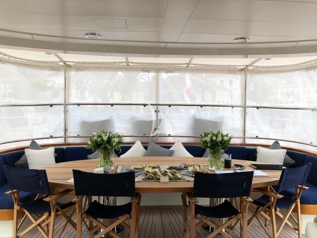 a room with a table and chairs aboard VICTORIA A Yacht for Charter