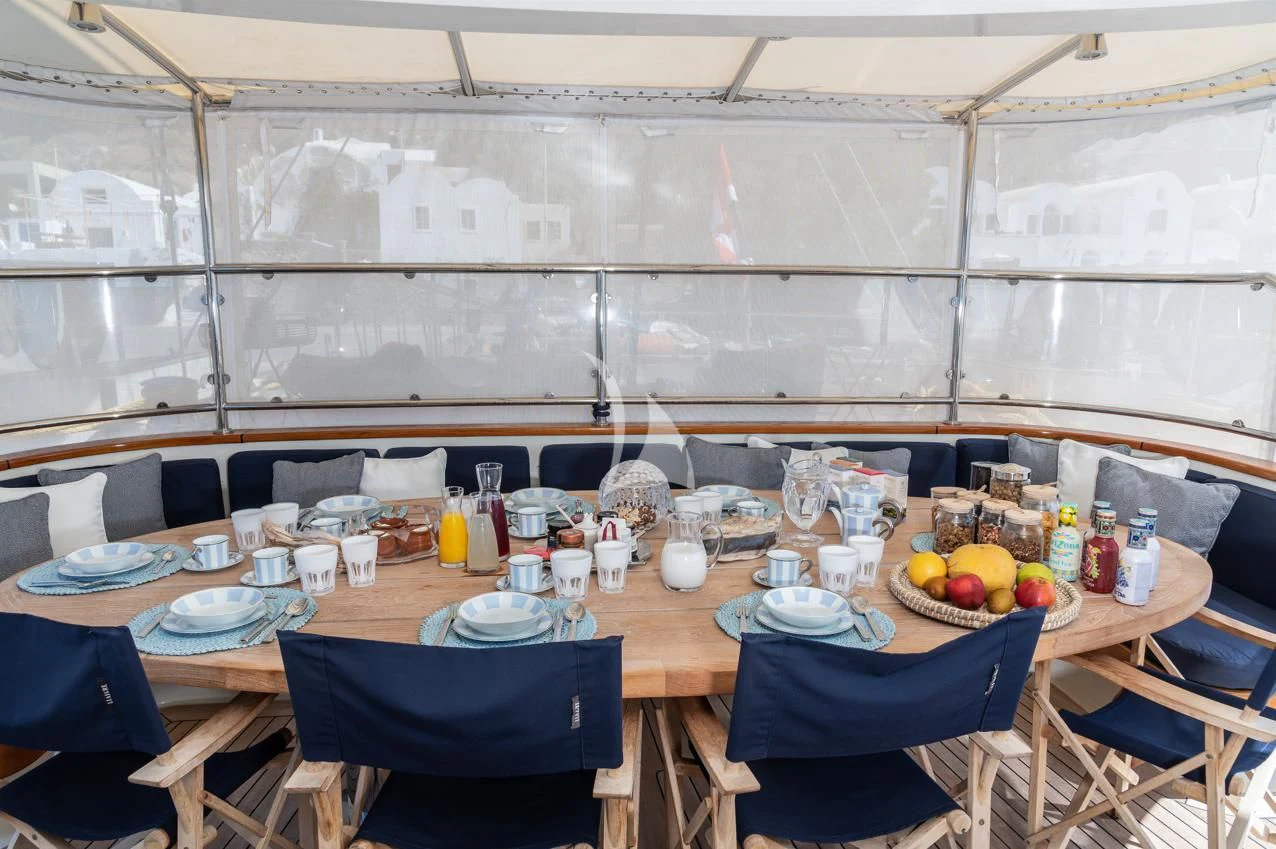 a table with plates and food on it aboard VICTORIA A Yacht for Charter