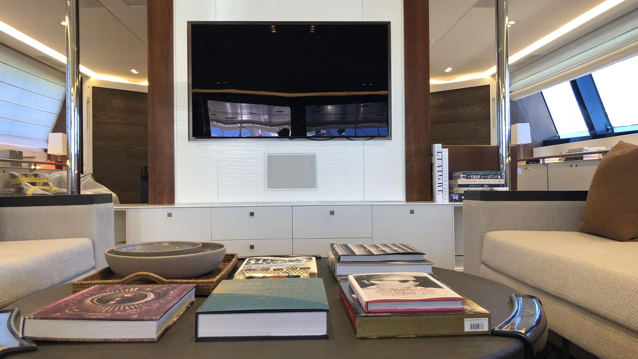 a living room with a tv and a table aboard VICTORIA A Yacht for Charter