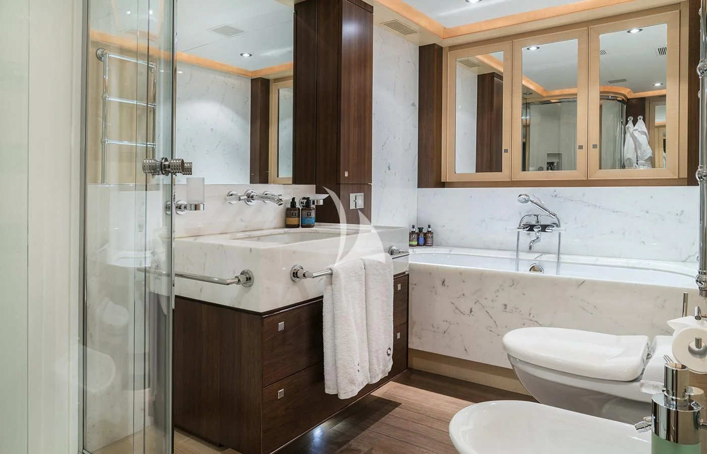 a bathroom with a tub sink and cabinets aboard VICTORIA A Yacht for Charter
