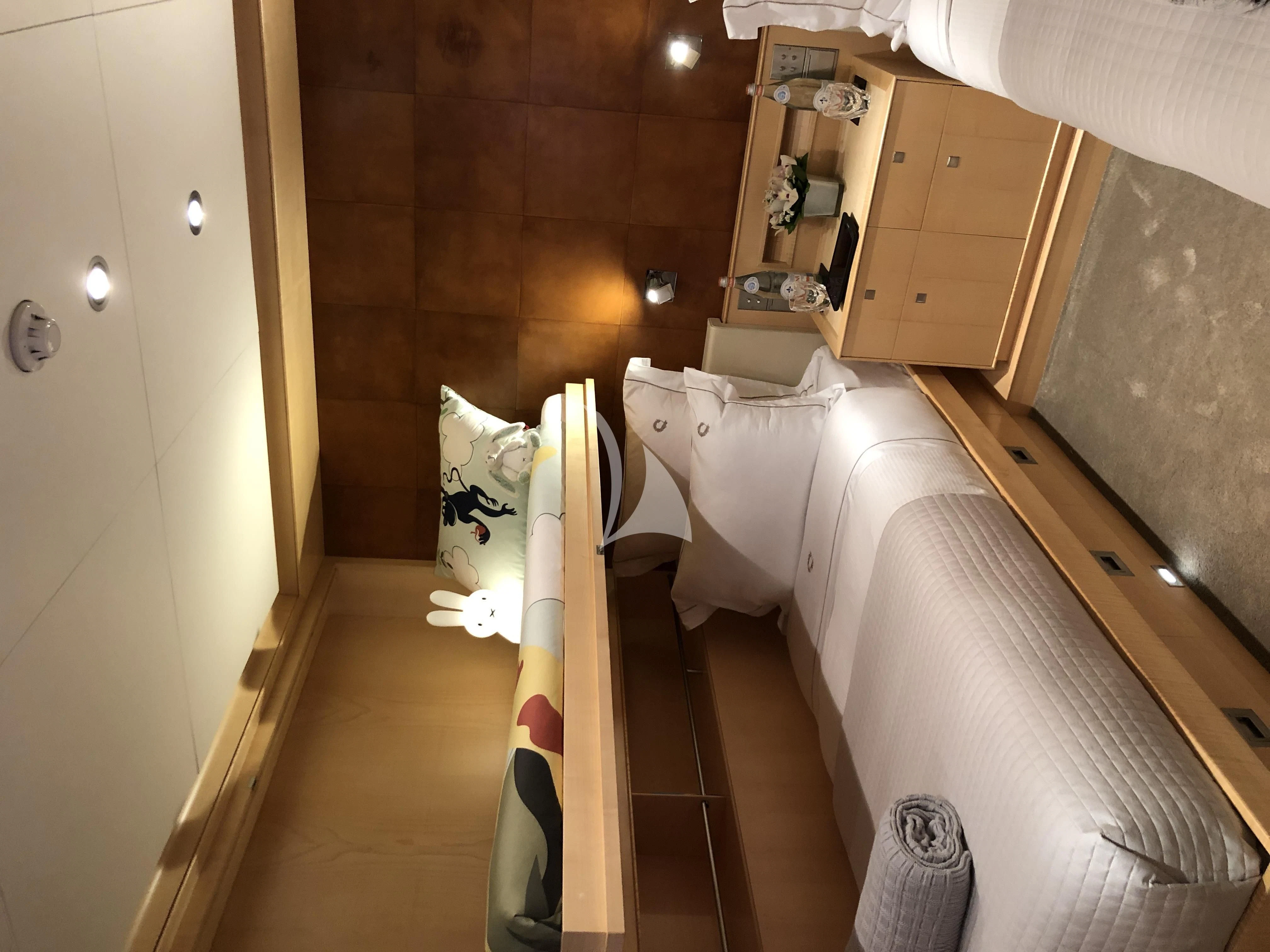 a room with a bed and a dresser aboard VICTORIA A Yacht for Charter