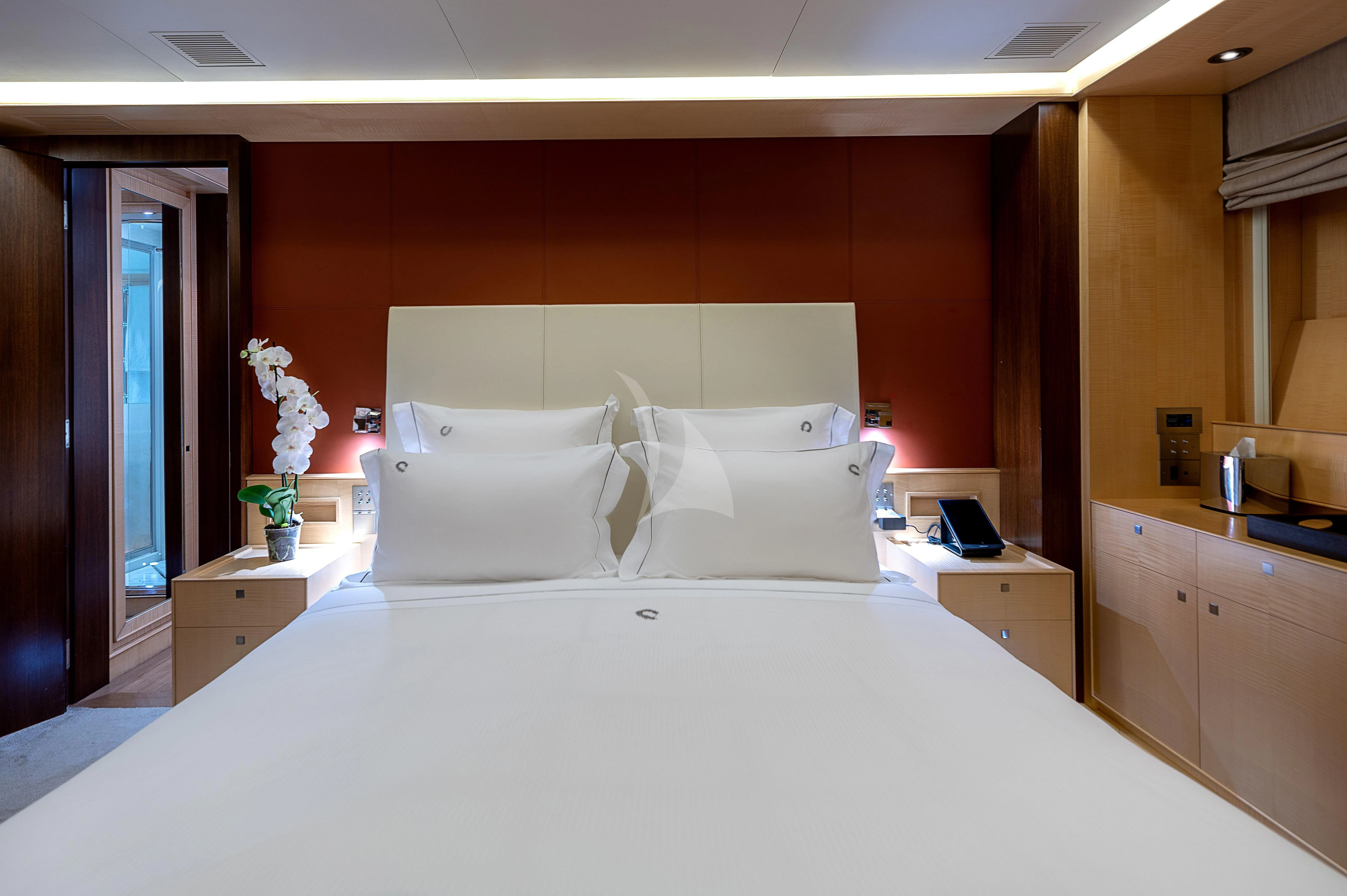 a bed with white sheets aboard VICTORIA A Yacht for Charter