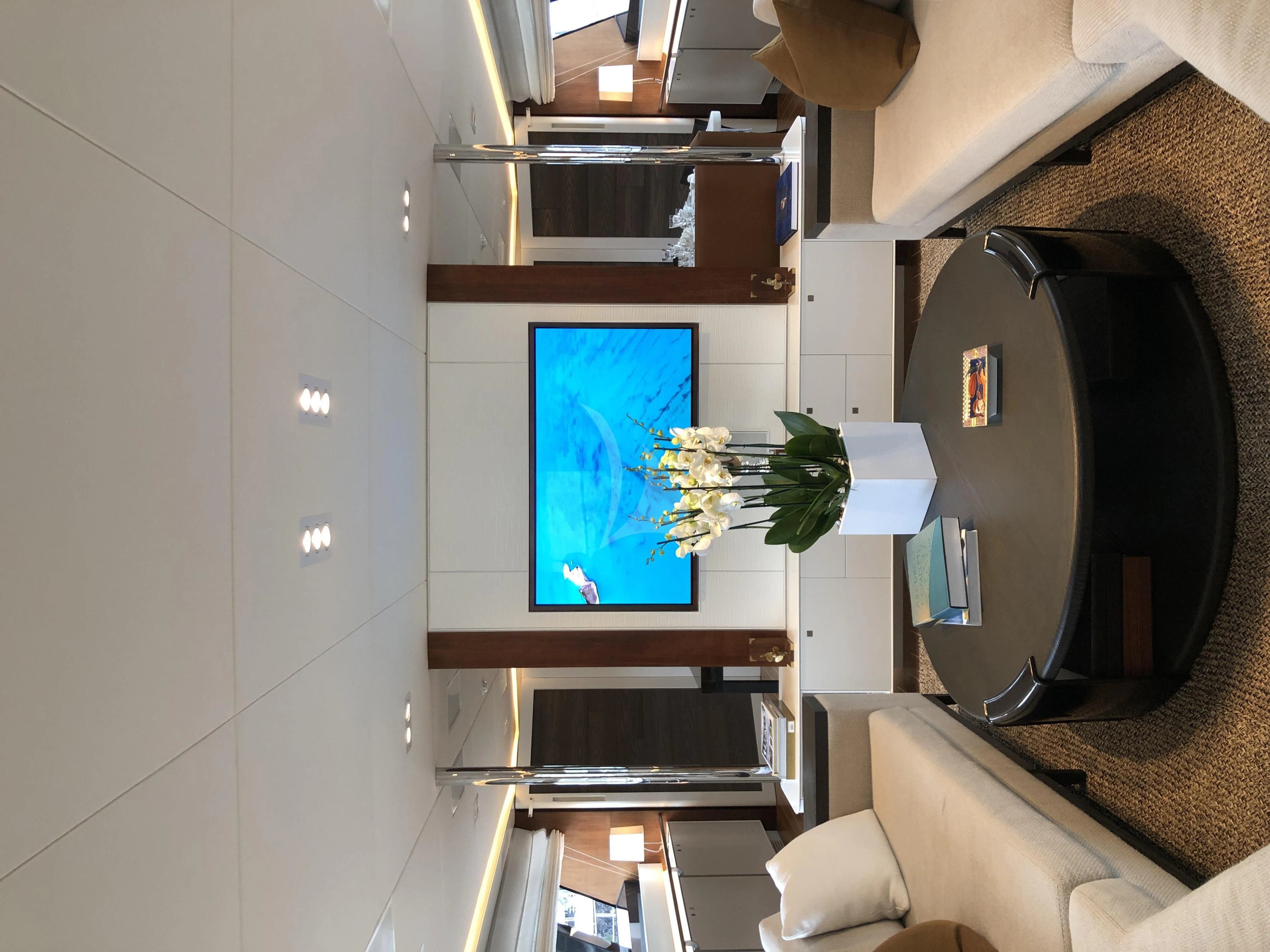 a room with a television and a chair aboard VICTORIA A Yacht for Charter