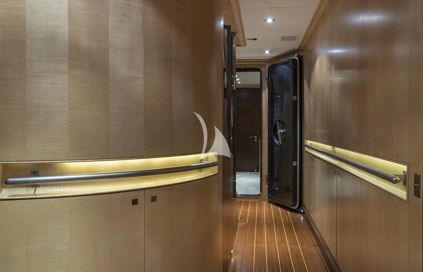 a room with a wood floor and cabinets aboard VICTORIA A Yacht for Charter