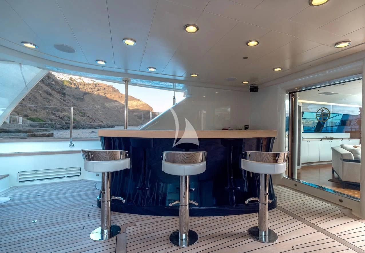 a bar with stools and stools on a deck aboard VICTORIA A Yacht for Charter