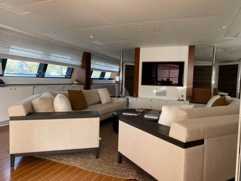 a living room with a couch and a tv aboard VICTORIA A Yacht for Charter
