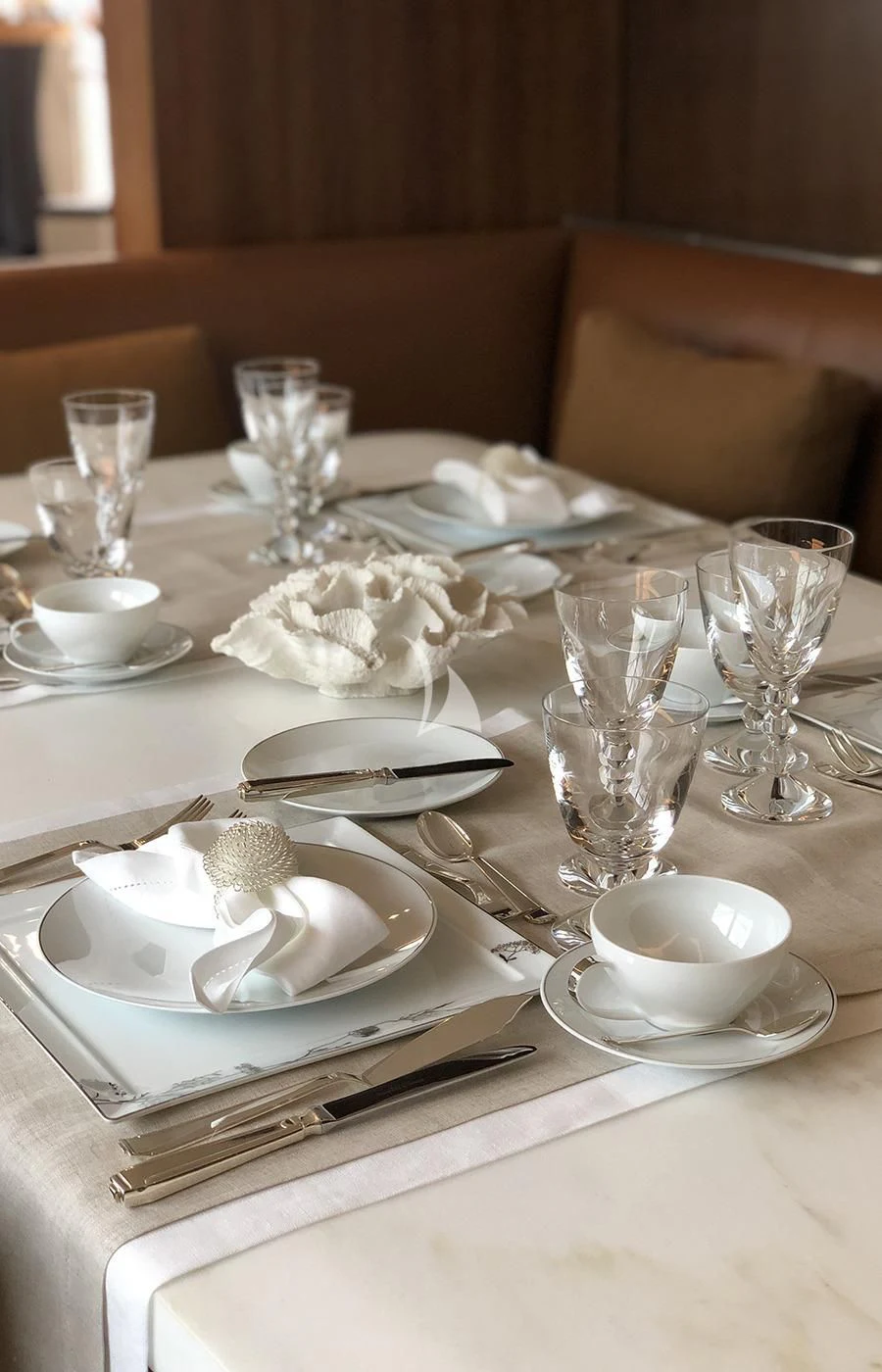 a table with plates and silverware aboard VICTORIA A Yacht for Charter