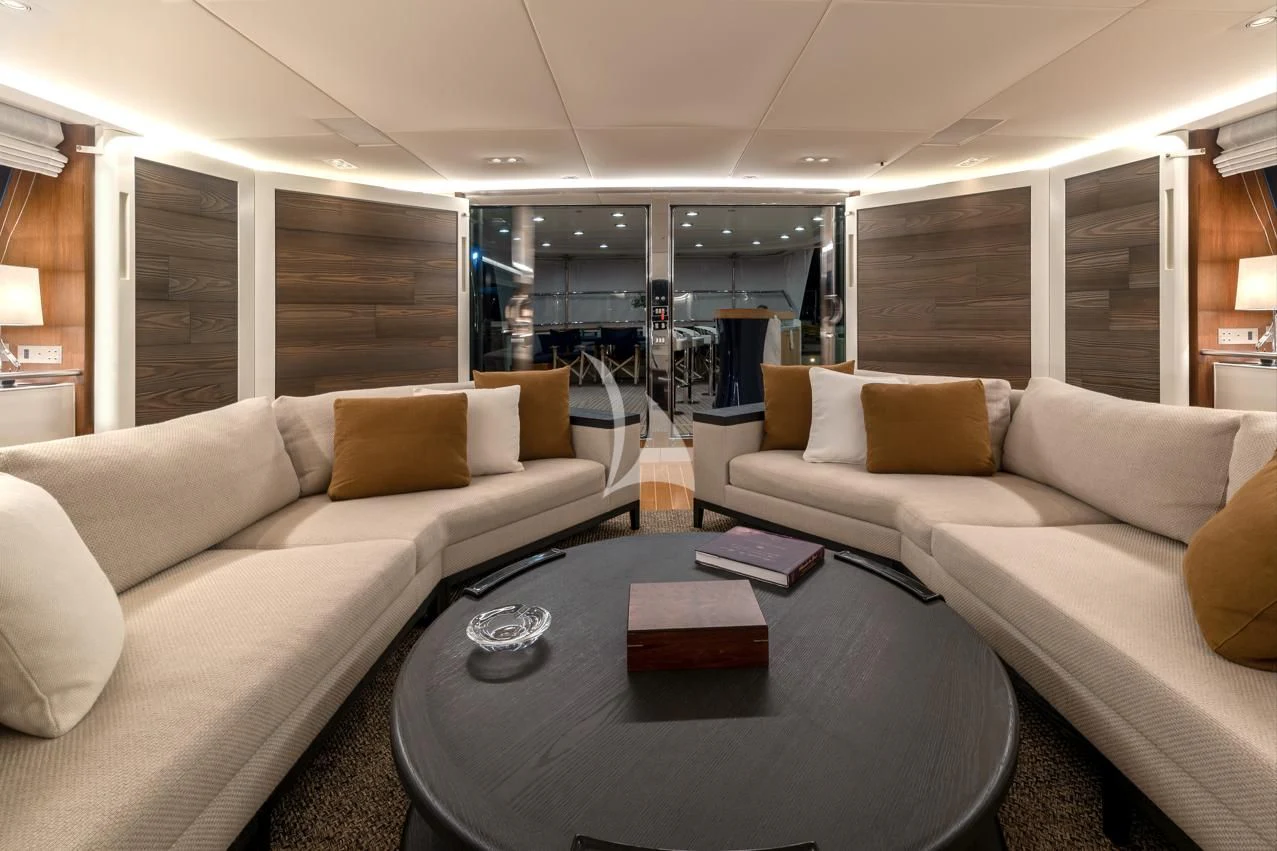 a living room with a couch and a table aboard VICTORIA A Yacht for Charter