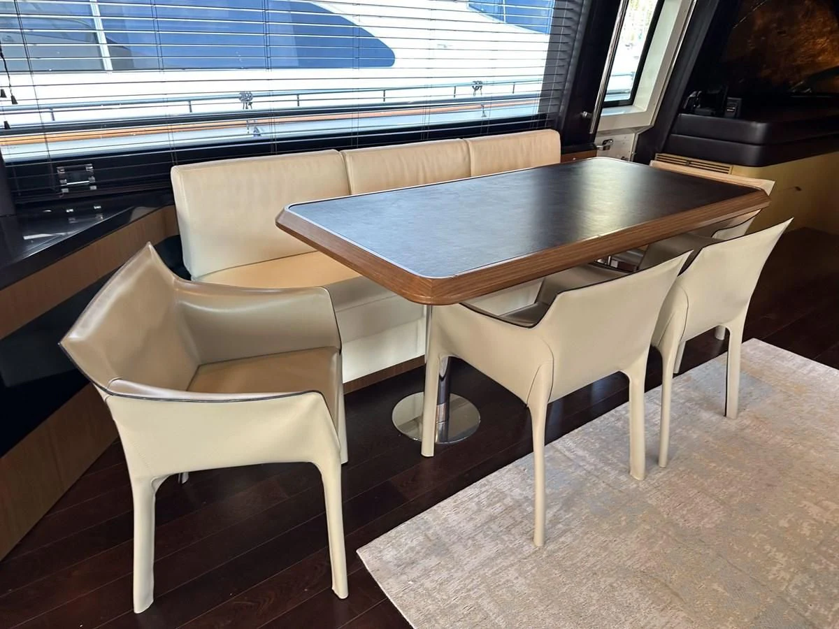 a table and chairs in a room aboard CHARISMA II Yacht for Sale
