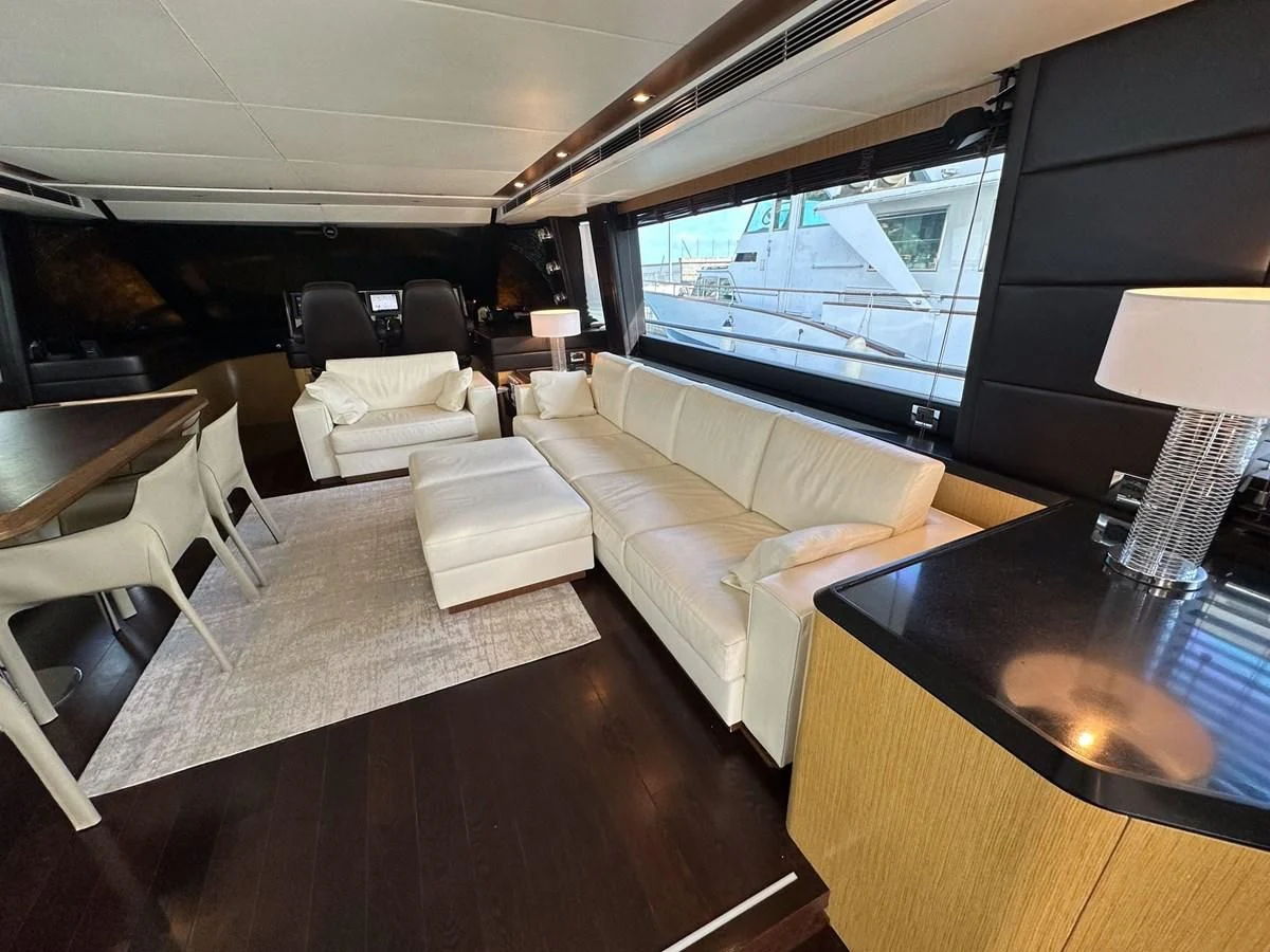 a living room with a large screen aboard CHARISMA II Yacht for Sale