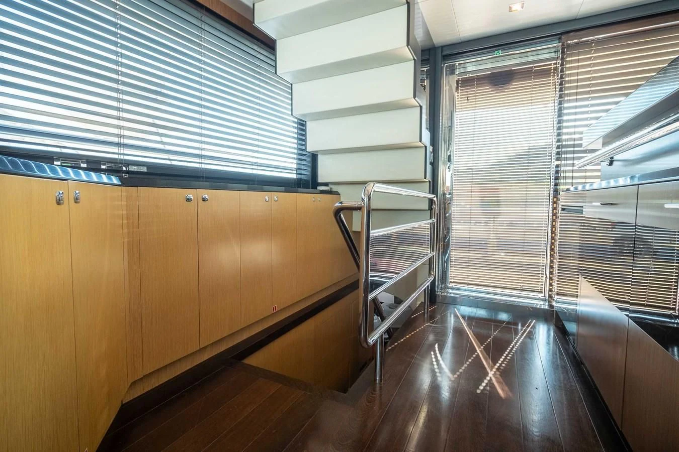 a room with wooden floors and a staircase aboard CHARISMA II Yacht for Sale