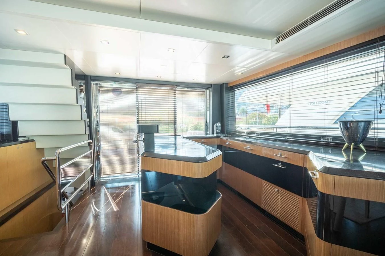 a room with a large window and a table with chairs aboard CHARISMA II Yacht for Sale