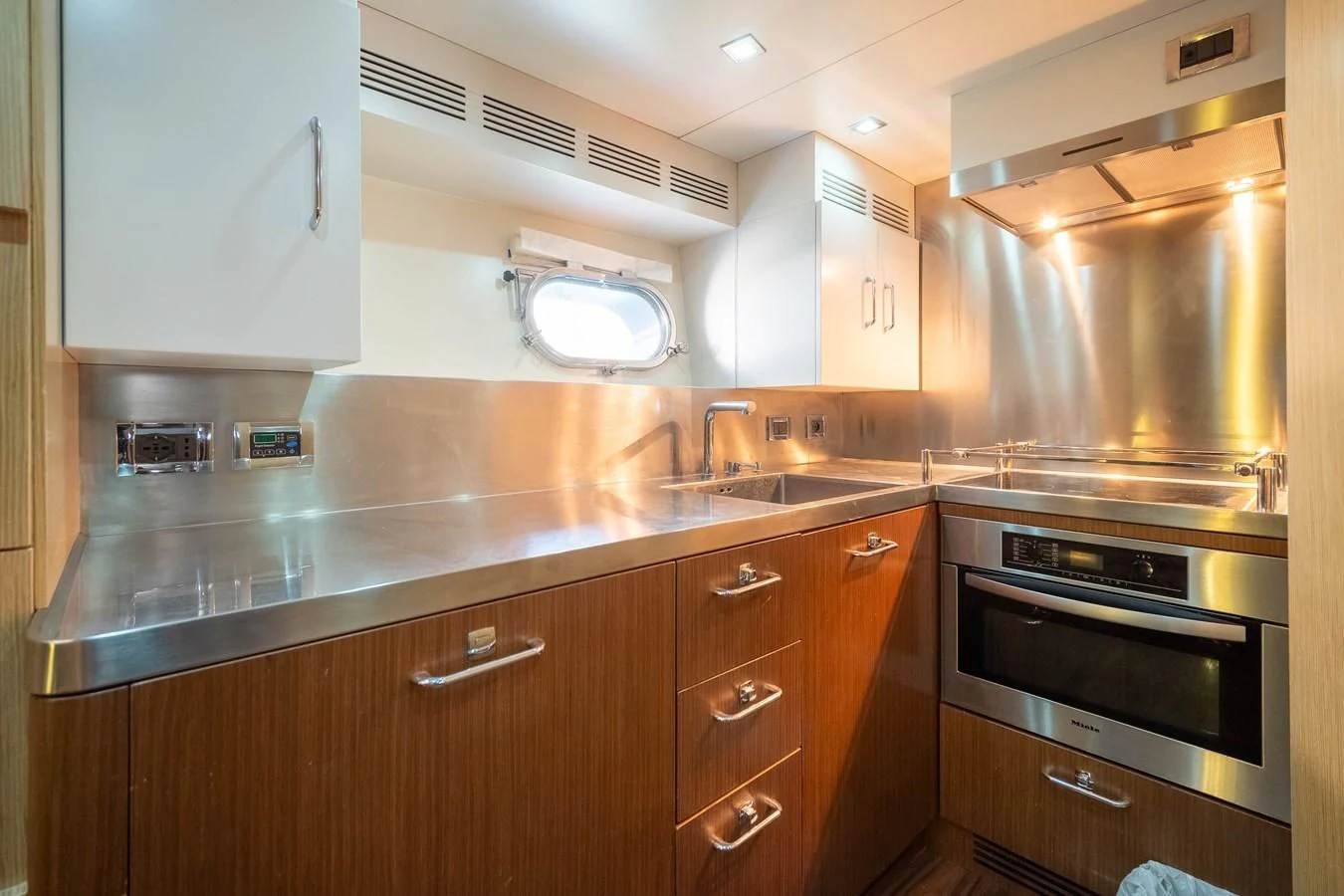 a kitchen with wooden cabinets aboard CHARISMA II Yacht for Sale