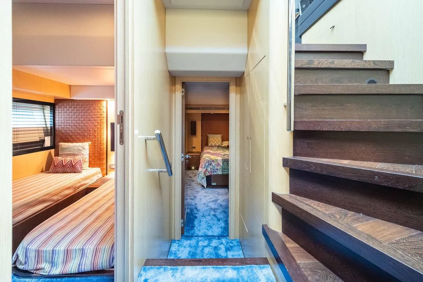 a room with a bed and a staircase aboard CHARISMA II Yacht for Sale