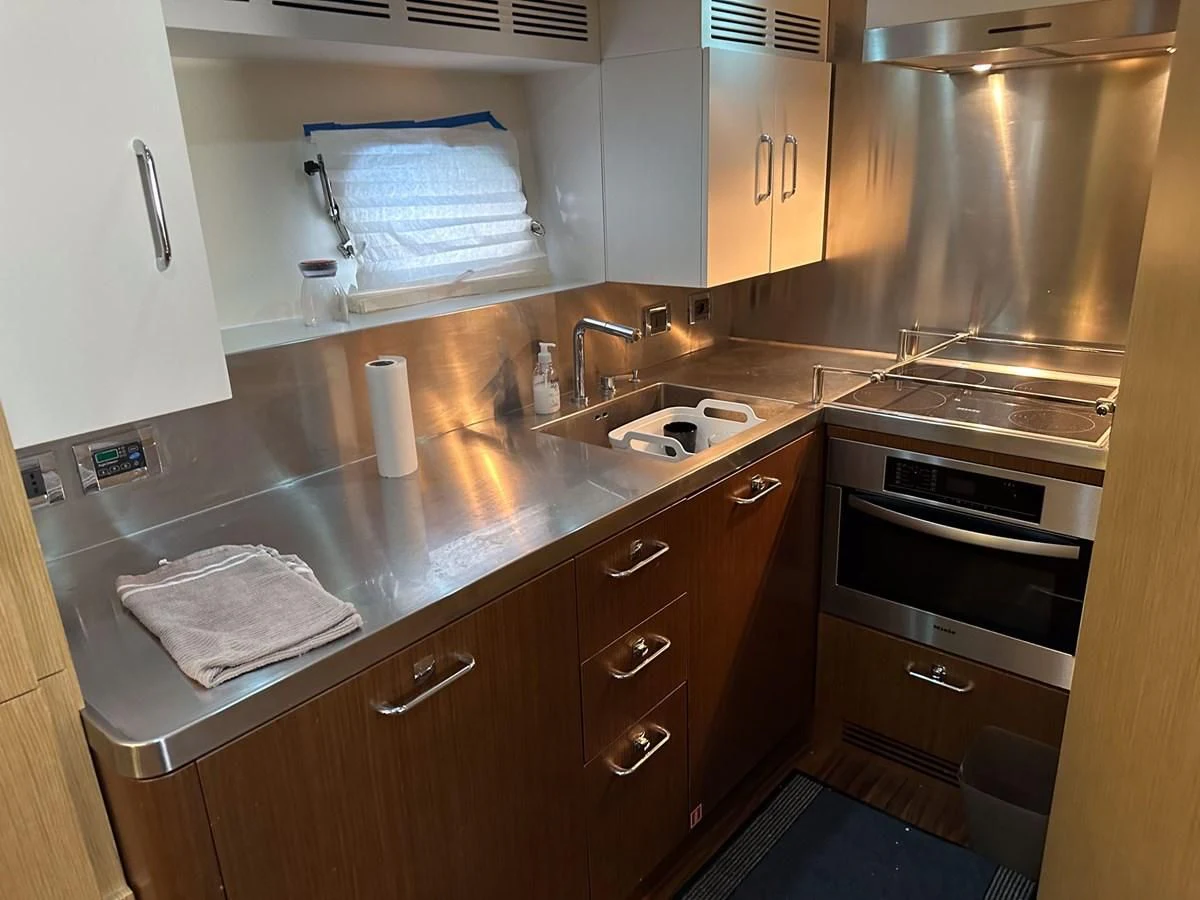 a kitchen with wooden cabinets aboard CHARISMA II Yacht for Sale
