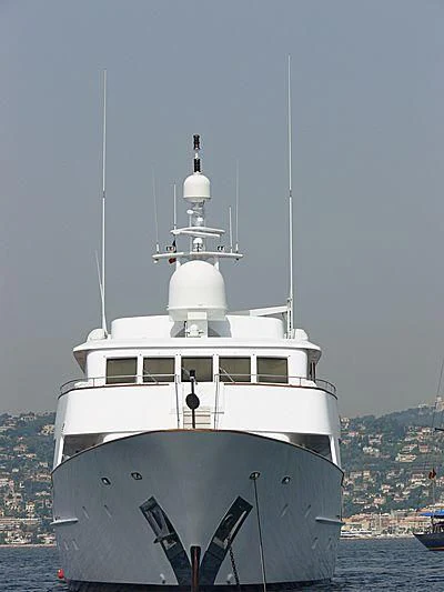 a white boat with a white tower aboard COMMITMENT Yacht for Sale