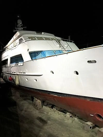 a white yacht on a beach aboard COMMITMENT Yacht for Sale