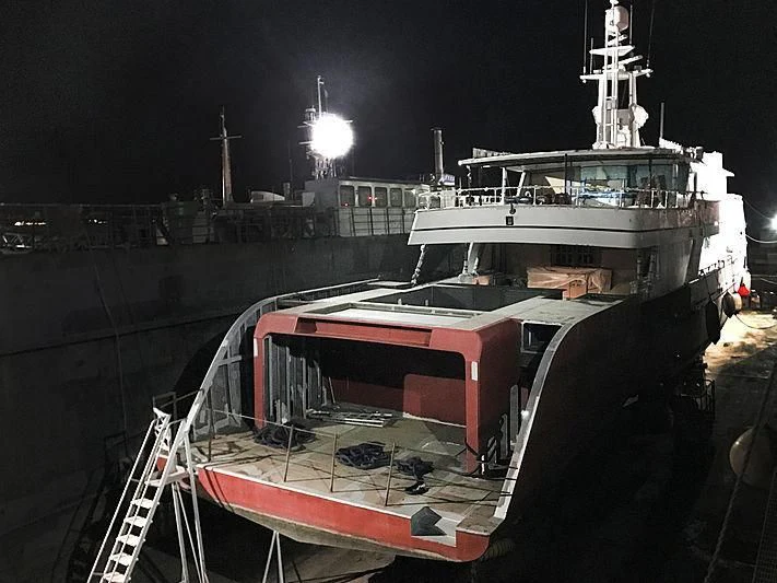 a boat docked at night aboard COMMITMENT Yacht for Sale