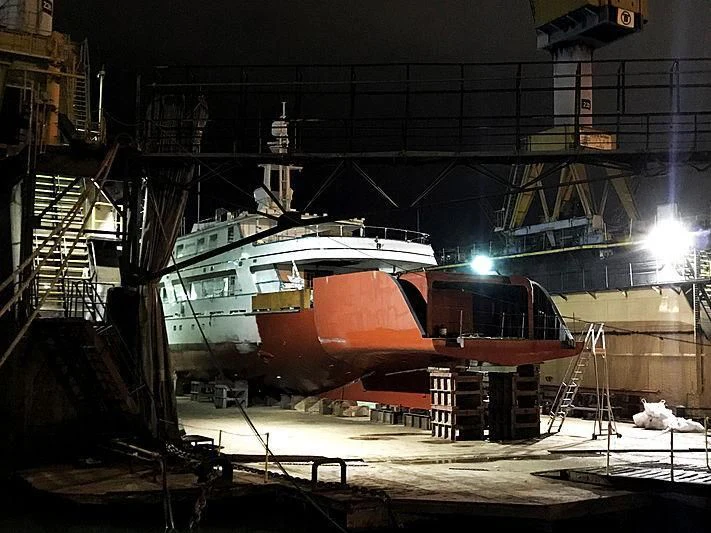 a large ship in a dock aboard COMMITMENT Yacht for Sale