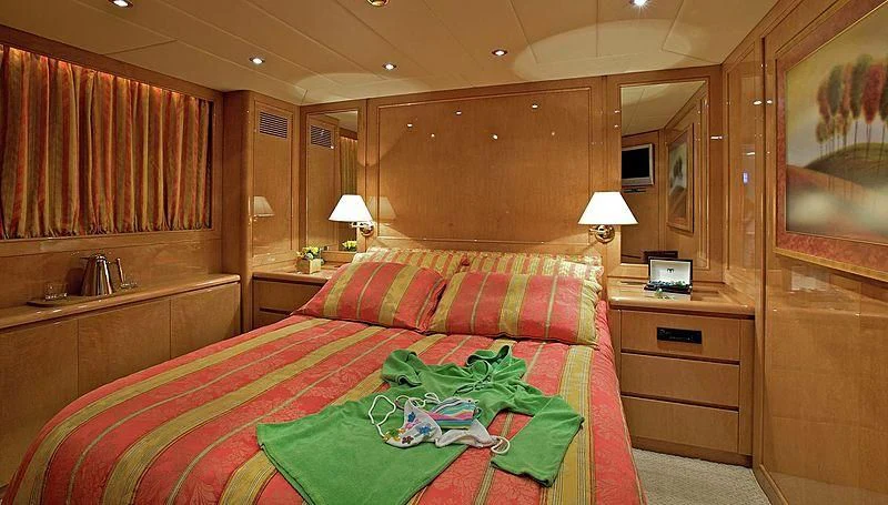 a bedroom with a bed and a desk aboard IDYLLE Yacht for Sale