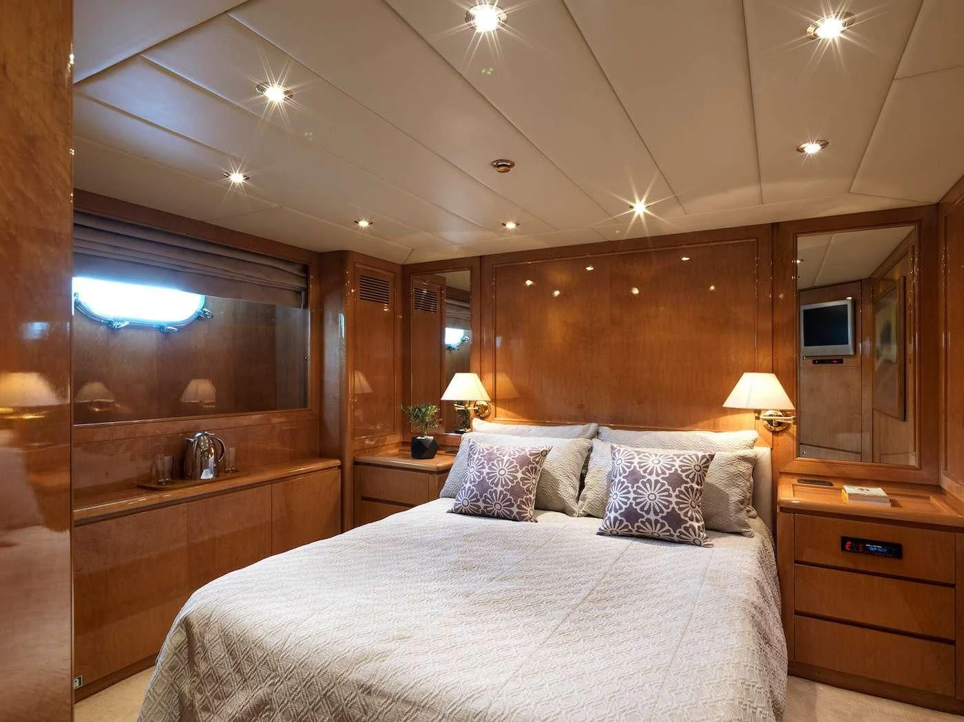 a bedroom with a bed and a desk aboard IDYLLE Yacht for Sale