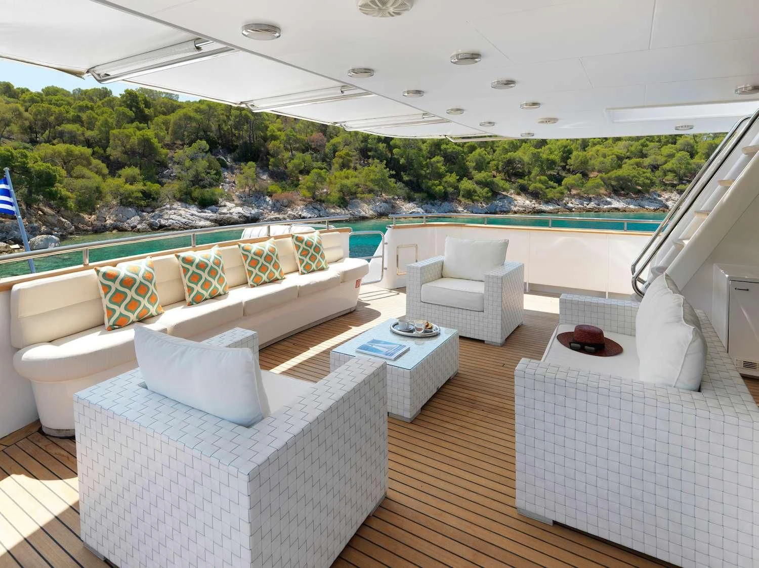 a room with a pool and a deck with chairs and a deck aboard IDYLLE Yacht for Sale