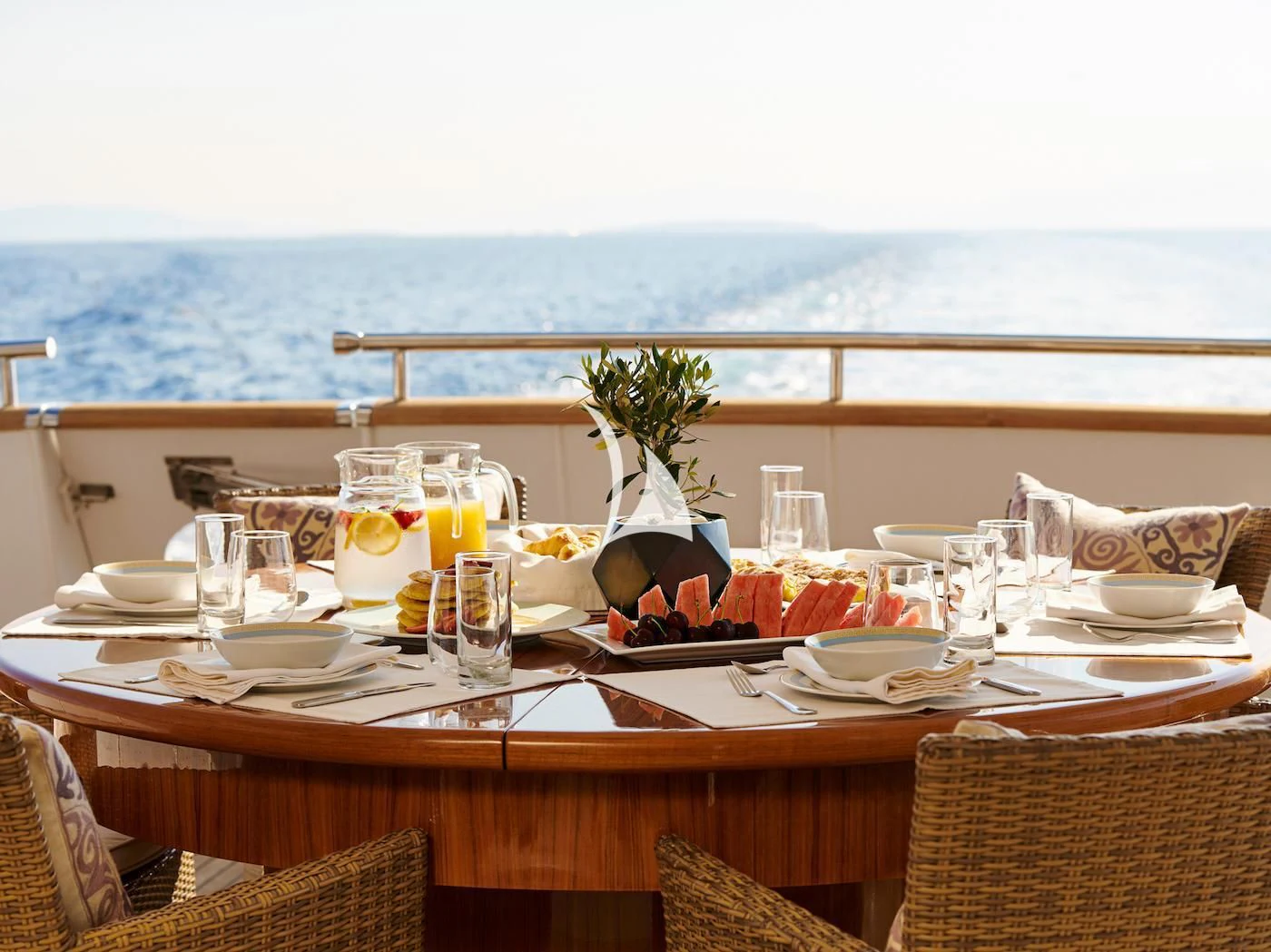 a table with food and drinks on it aboard IDYLLE Yacht for Sale