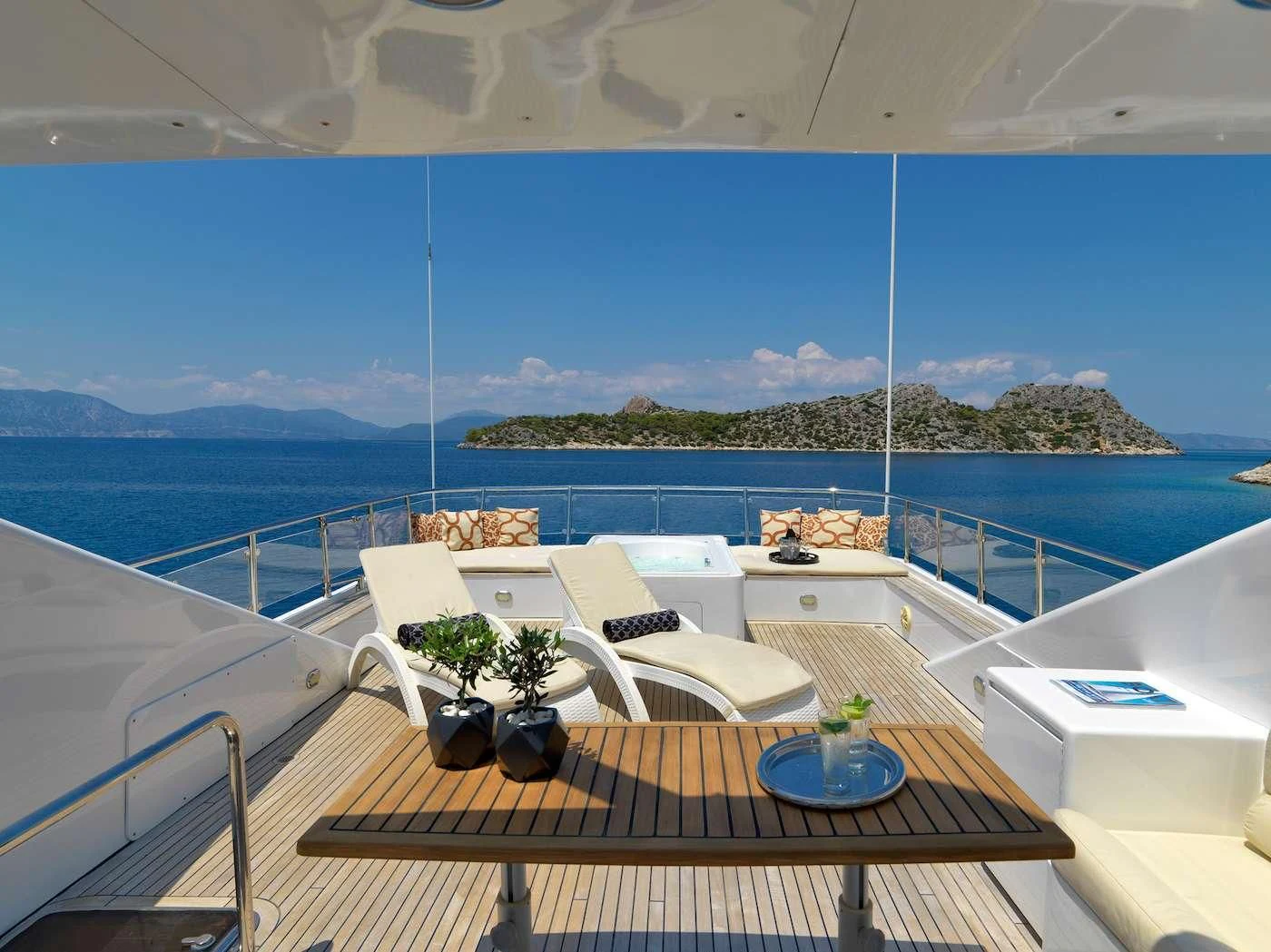 a balcony with a table and chairs aboard IDYLLE Yacht for Sale