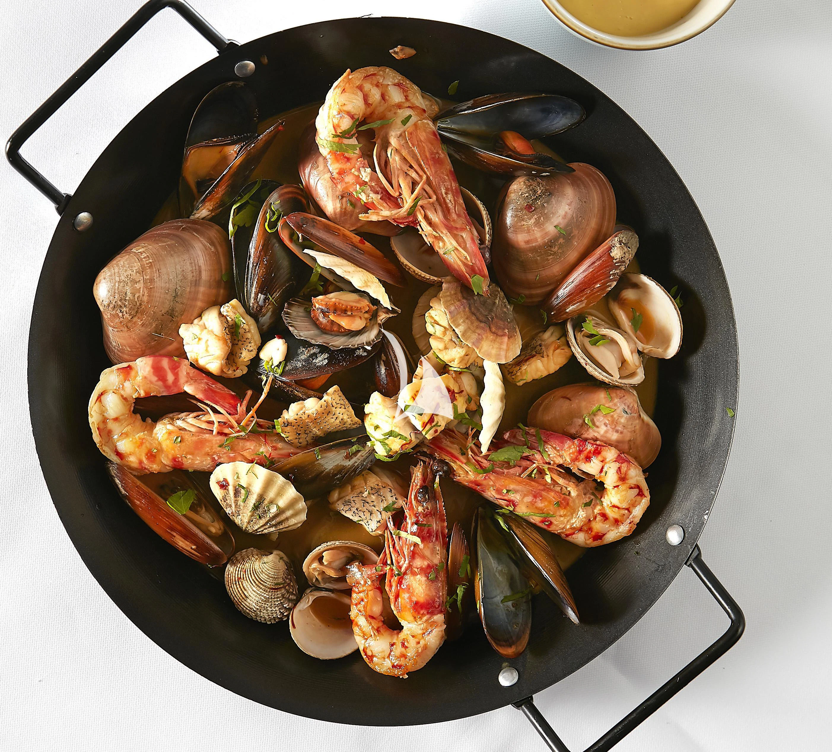 a pan of food on a stove aboard IDYLLE Yacht for Sale