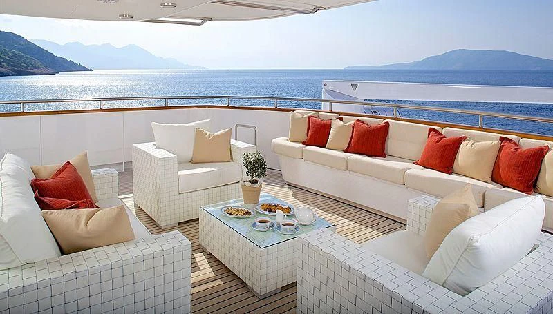 a living room with couches and a table aboard IDYLLE Yacht for Sale