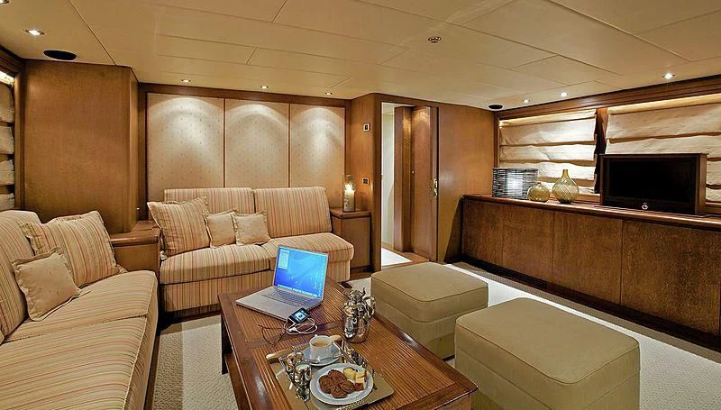 a living room with a laptop on a table aboard IDYLLE Yacht for Sale