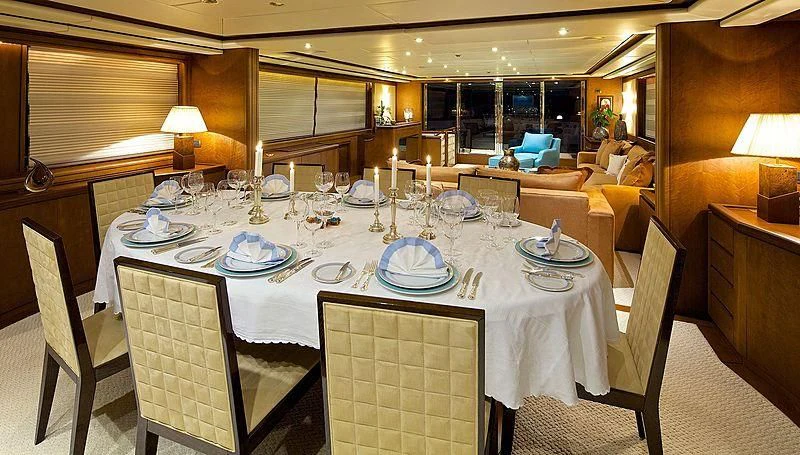 a dining room table set for a dinner party aboard IDYLLE Yacht for Sale