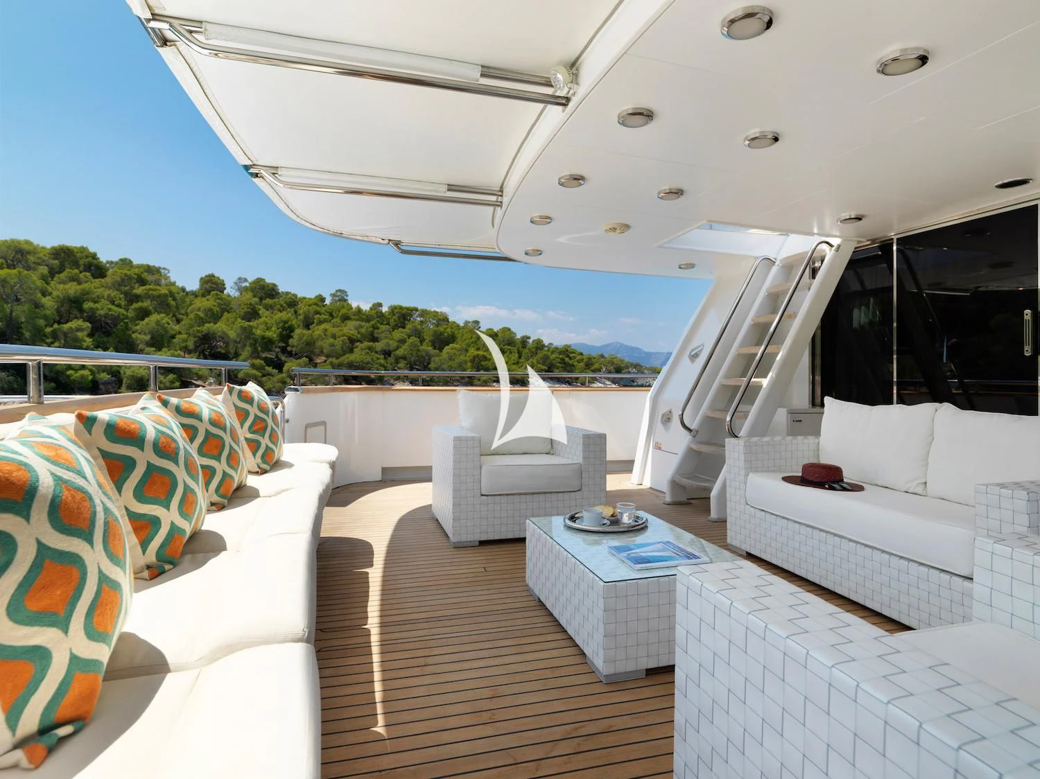 a white lounge chair on a deck aboard IDYLLE Yacht for Sale