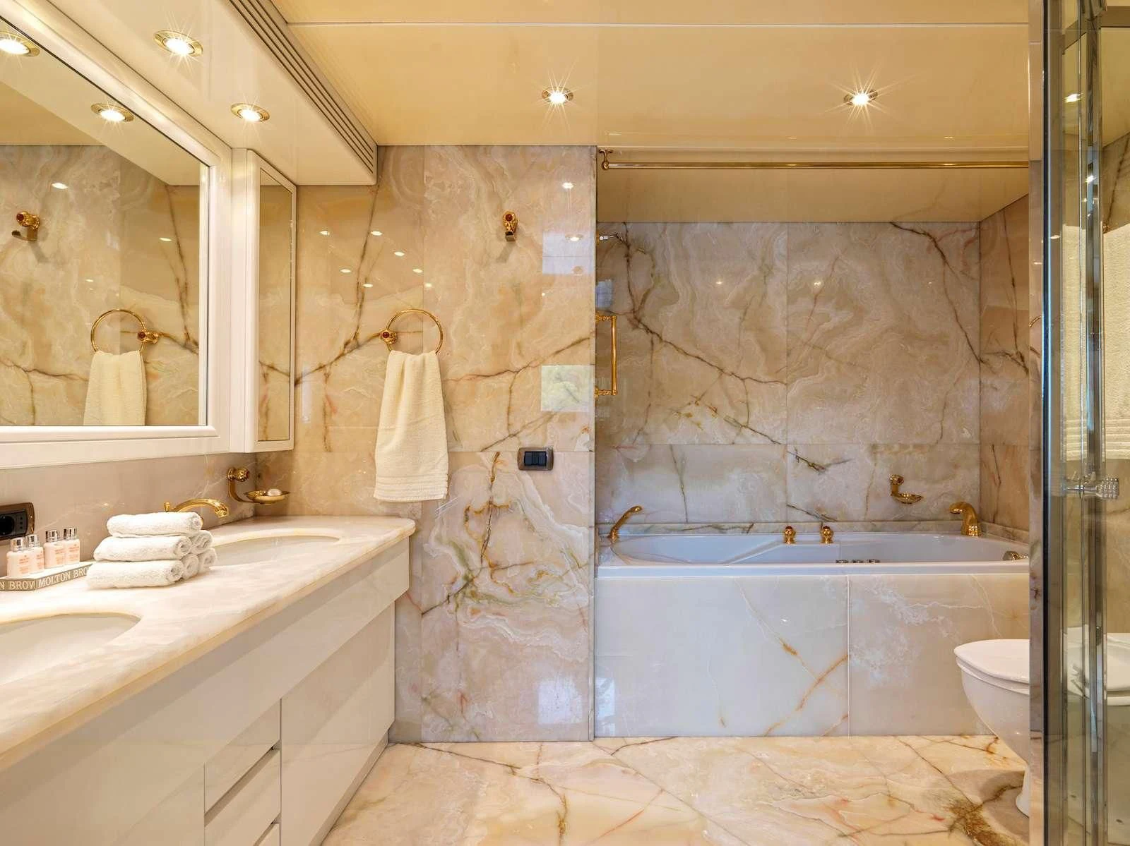 a bathroom with a bathtub and sink aboard IDYLLE Yacht for Sale