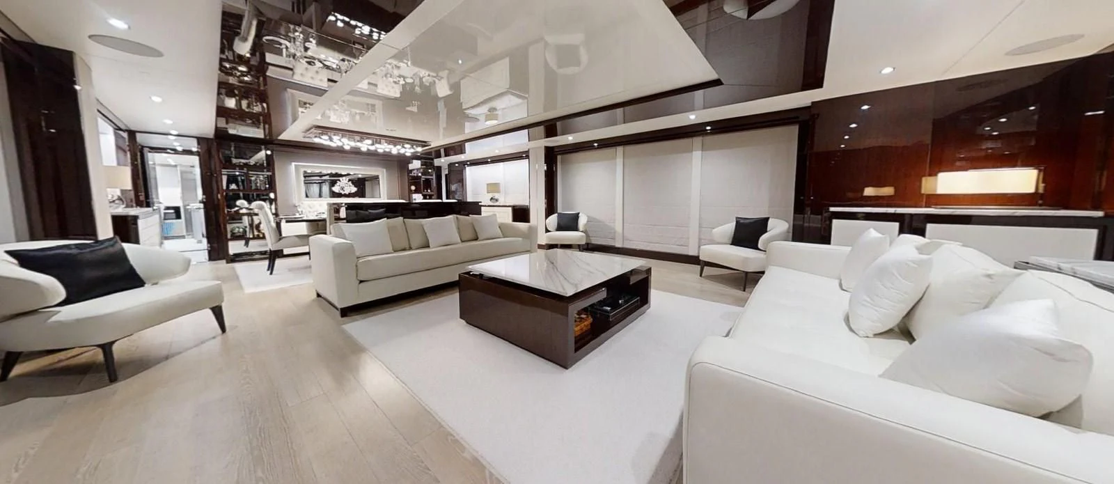 a room with white couches and a coffee table aboard NOAH Yacht for Charter