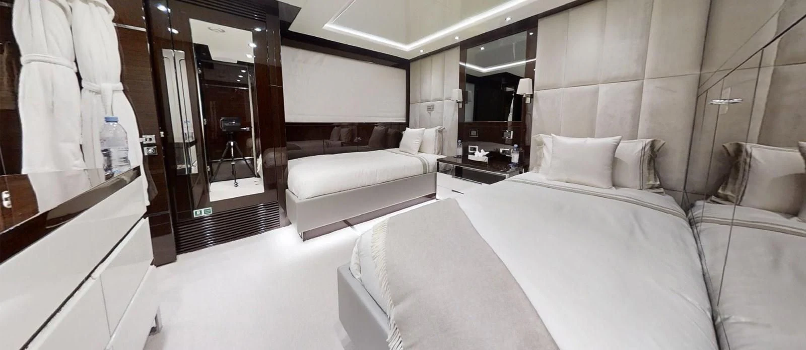 a room with a bed and a mirror aboard NOAH Yacht for Charter
