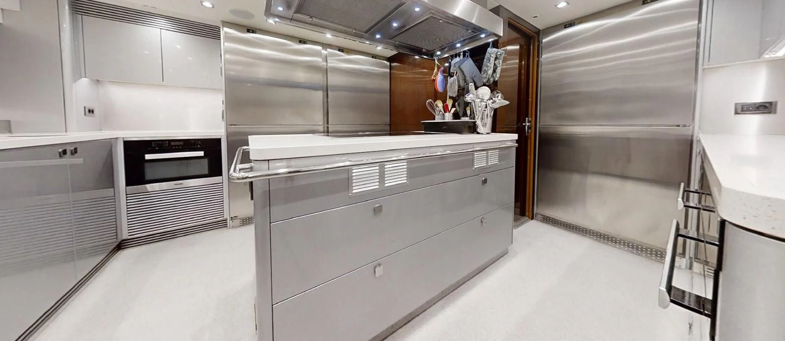 a large kitchen with white cabinets aboard NOAH Yacht for Charter