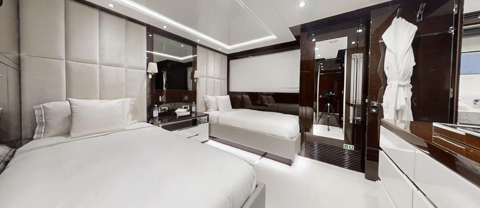 a room with a bed and a mirror aboard NOAH Yacht for Charter