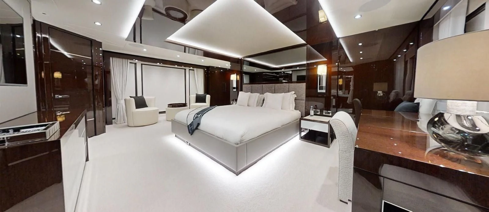 a room with a bed and a table aboard NOAH Yacht for Charter