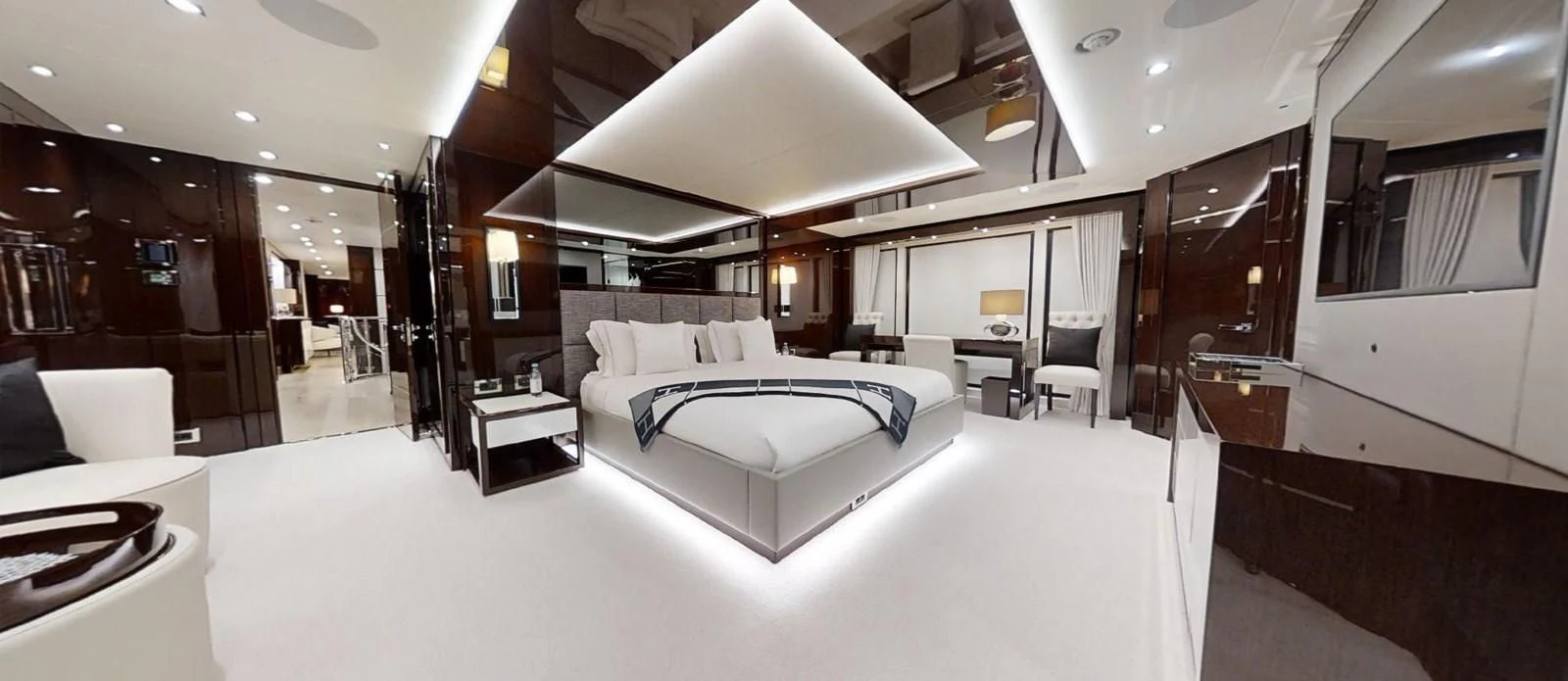 a large room with a bed and a desk aboard NOAH Yacht for Charter