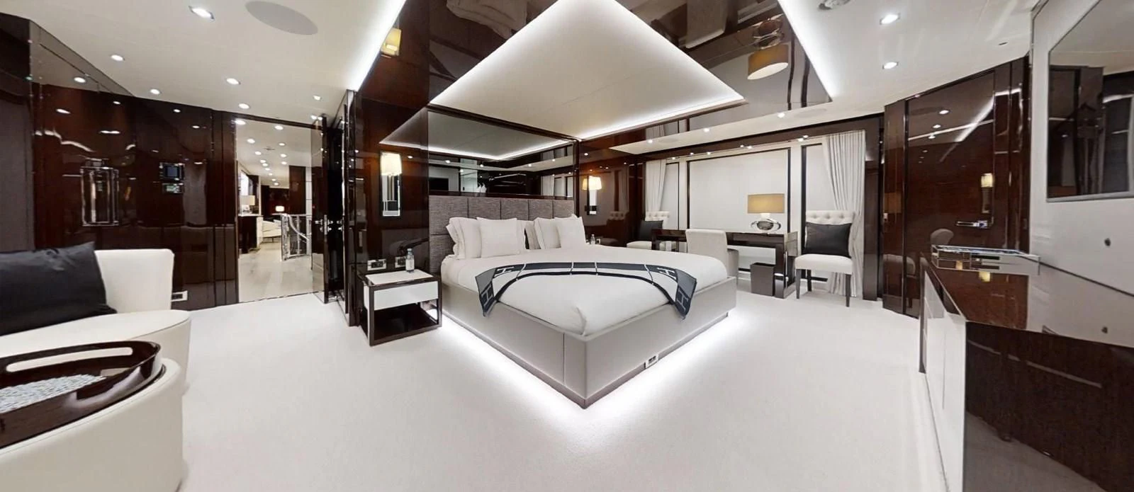 a large room with a bed and a chair aboard NOAH Yacht for Charter