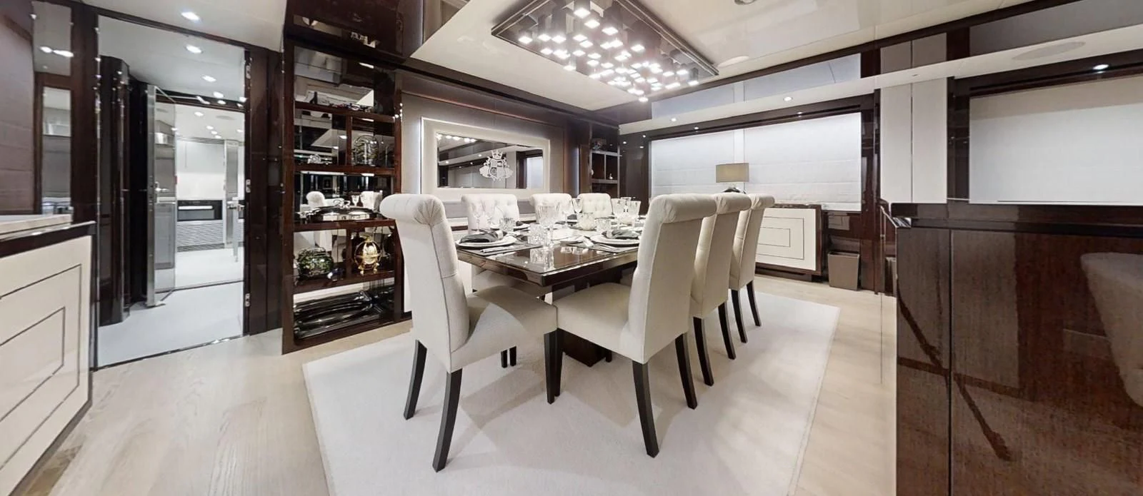 a room with a table chairs and shelves aboard NOAH Yacht for Charter