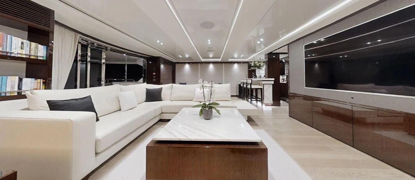 a room with a table and couch aboard NOAH Yacht for Charter
