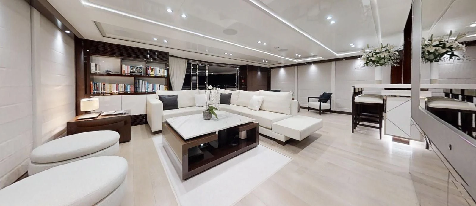 a large room with a table and chairs aboard NOAH Yacht for Charter