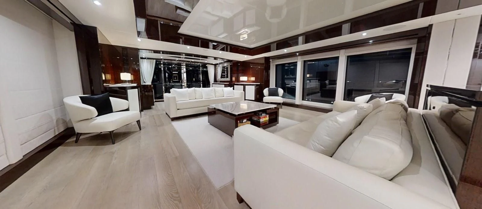 a living room with white couches aboard NOAH Yacht for Charter