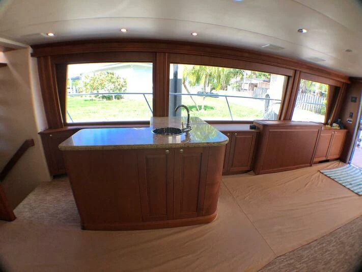 a kitchen with a bar and a pool table aboard ESCAPE Yacht for Sale