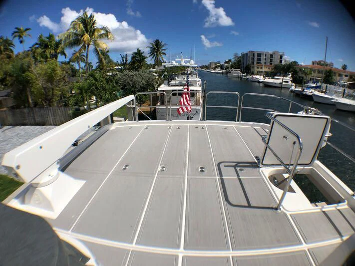 a large white boat in a harbor aboard ESCAPE Yacht for Sale