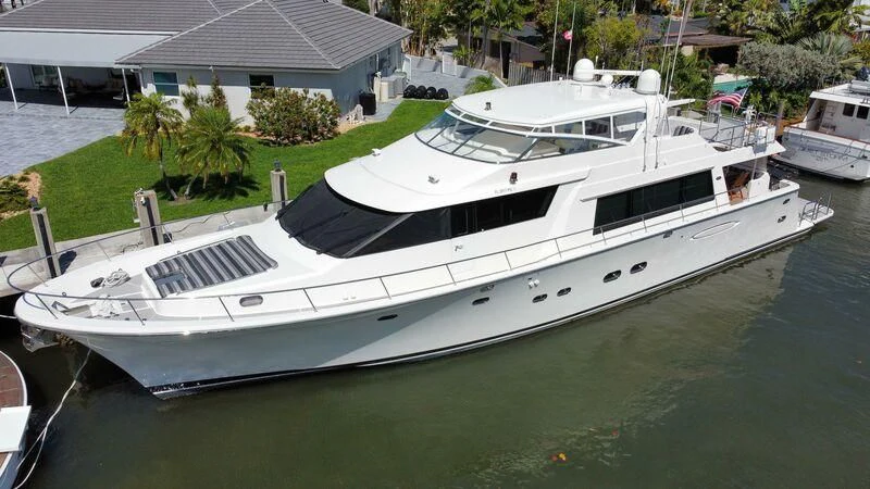 a white boat in a harbor aboard ESCAPE Yacht for Sale