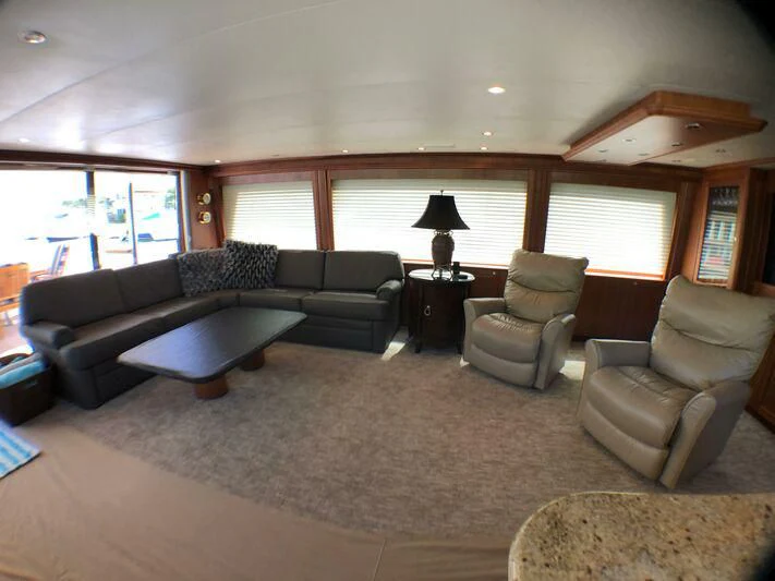 a living room with a couch and a coffee table aboard ESCAPE Yacht for Sale