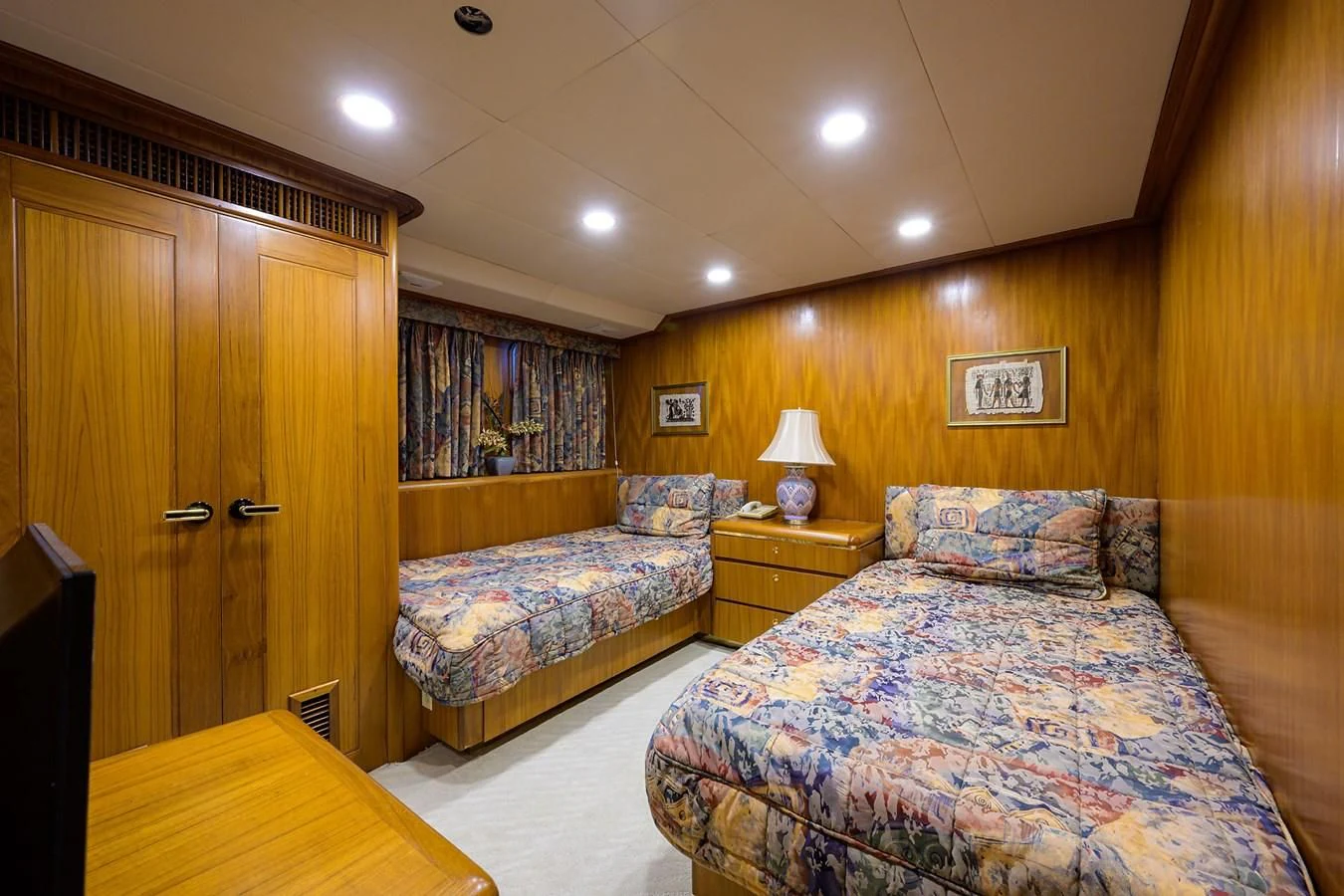 a bedroom with a bed and a desk aboard ARIES Yacht for Sale